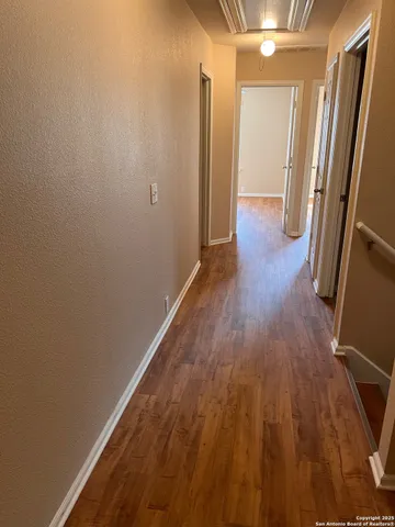 a view of a hallway and wooden floor
