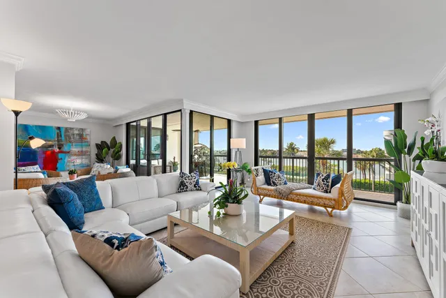 a view of a dining room with furniture a chandelier and wooden floor