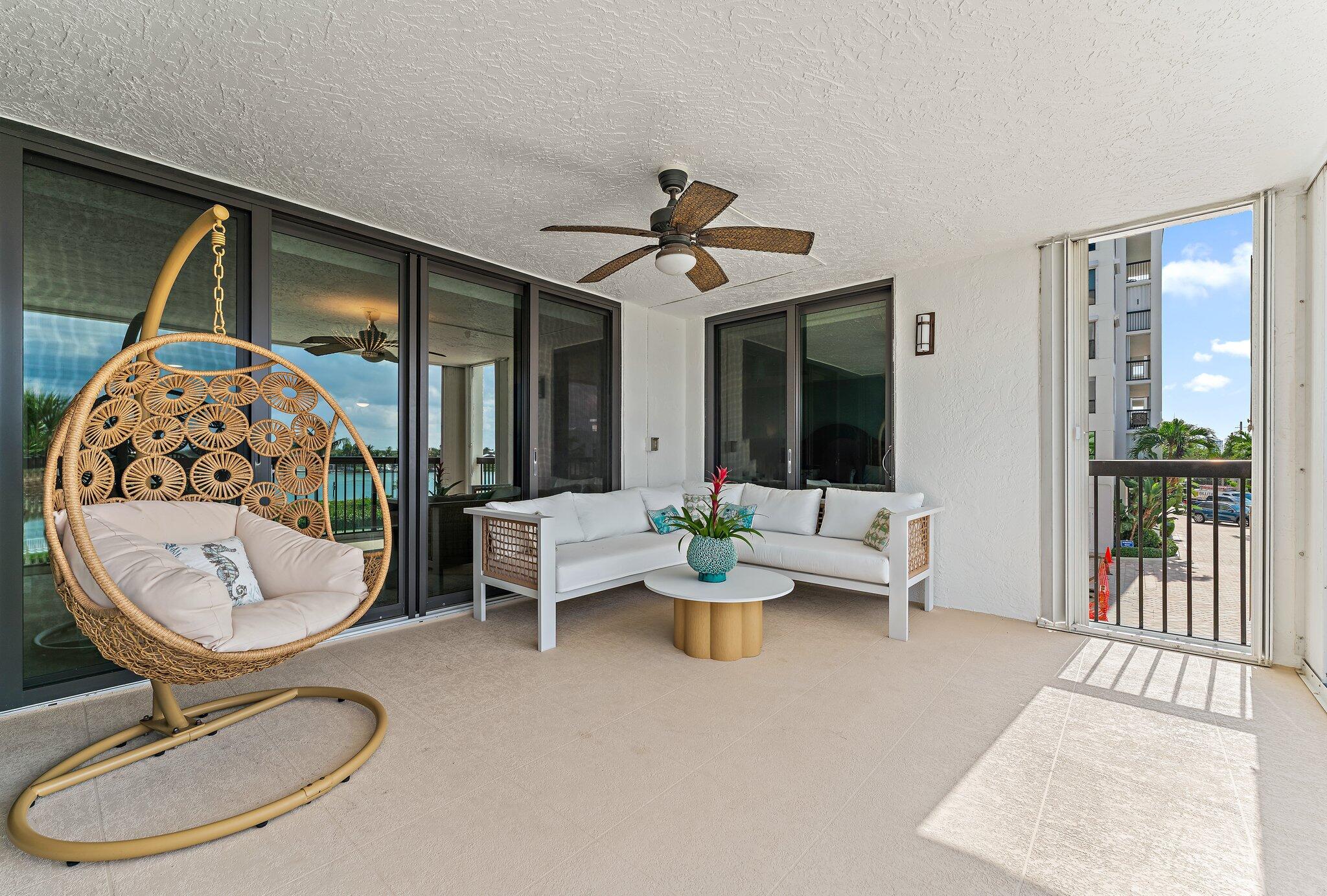 19670 South Beach Road, Unit B303 Jupiter, FL 33469 - Photo 19 of 104 a living room with furniture a window and a chandelier