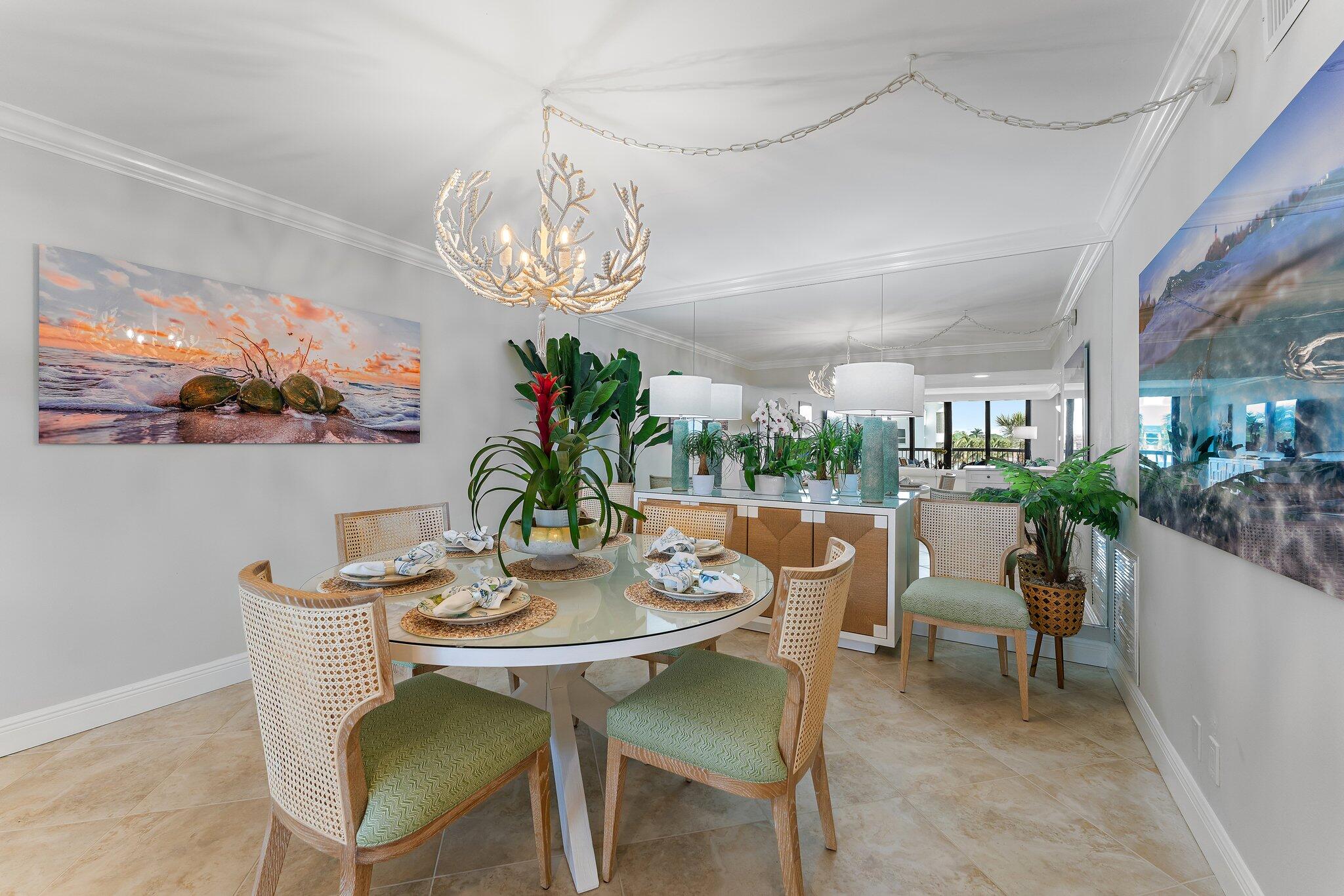 19670 South Beach Road, Unit B303 Jupiter, FL 33469 - Photo 26 of 104 a view of a dining room with furniture a chandelier and wooden floor