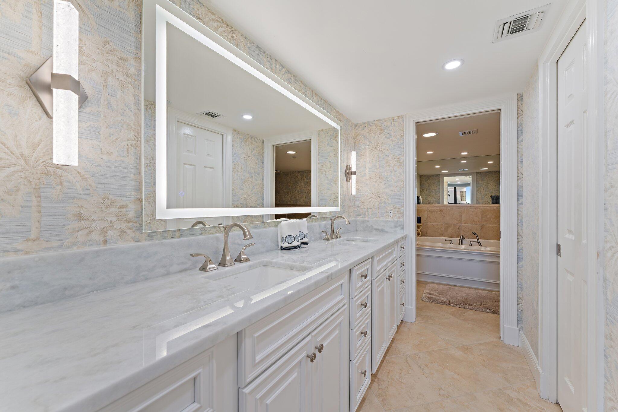 19670 South Beach Road, Unit B303 Jupiter, FL 33469 - Photo 32 of 104 a spacious bathroom with a double vanity sink and a mirror