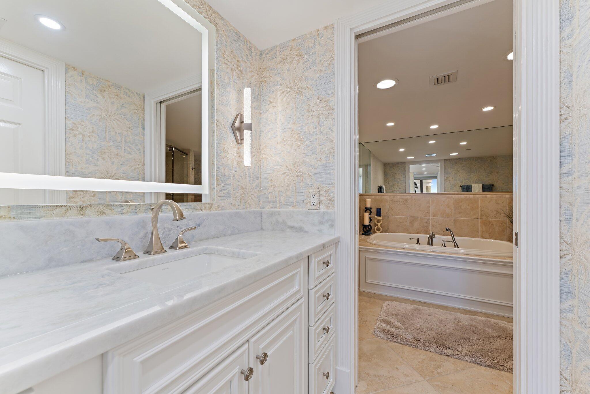 19670 South Beach Road, Unit B303 Jupiter, FL 33469 - Photo 33 of 104 a bathroom with a sink and a mirror