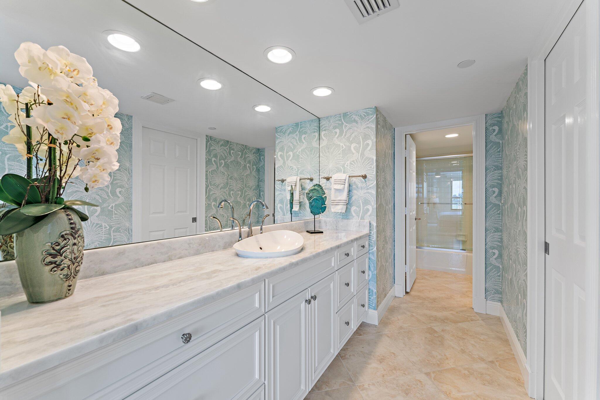 19670 South Beach Road, Unit B303 Jupiter, FL 33469 - Photo 43 of 104 a bathroom with a sink and a mirror