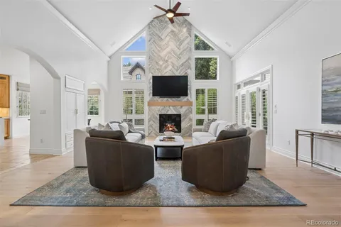 a living room with furniture a flat screen tv and a fireplace