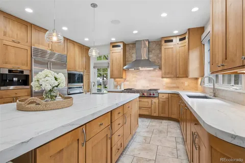 a view of a kitchen with a dining table chairs and a wooden floor