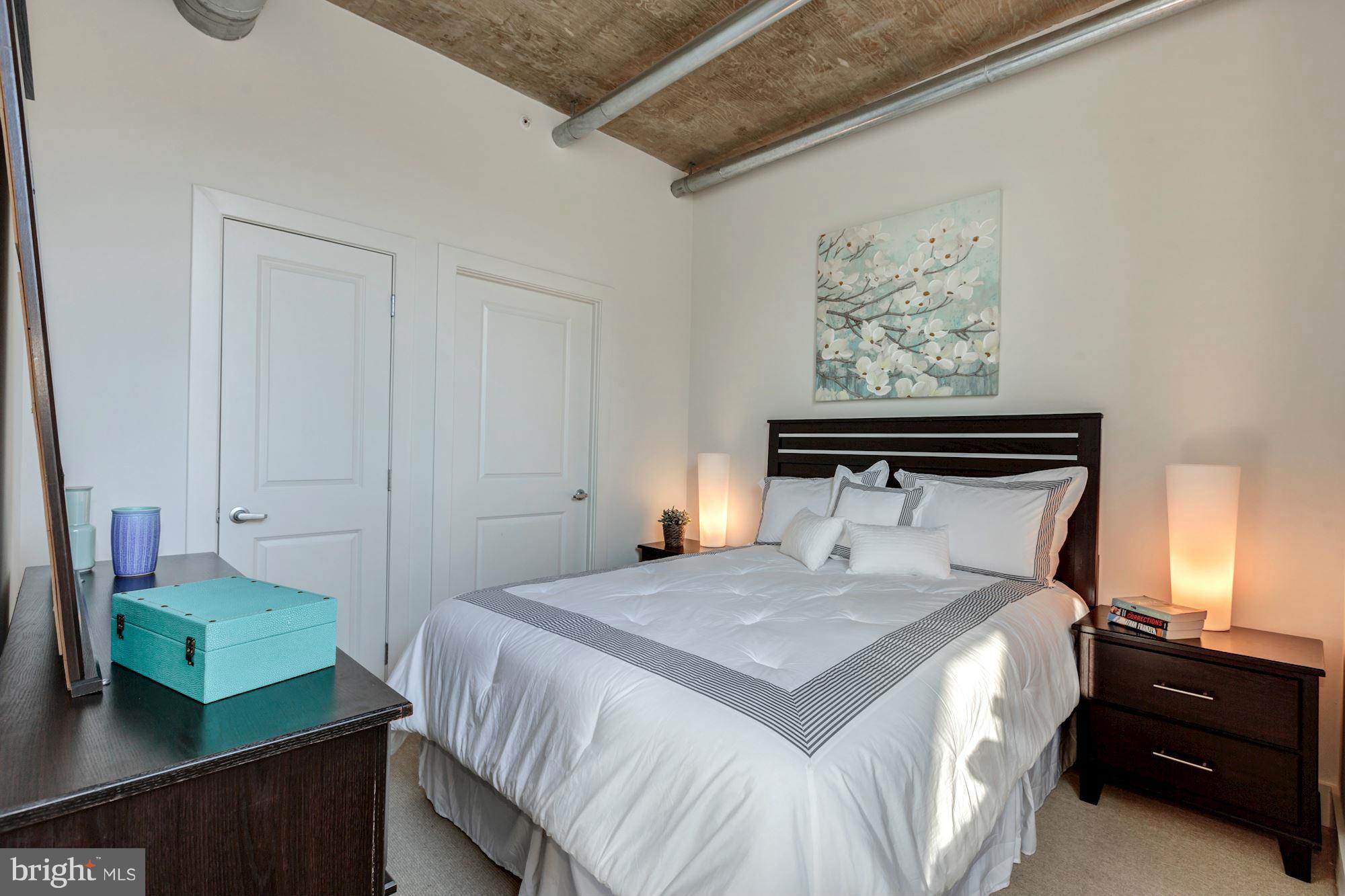 2301 Champlain Street Northwest, Unit 112 Washington, DC 20009 - Photo 13 of 29 a bedroom with a bed and a night stand