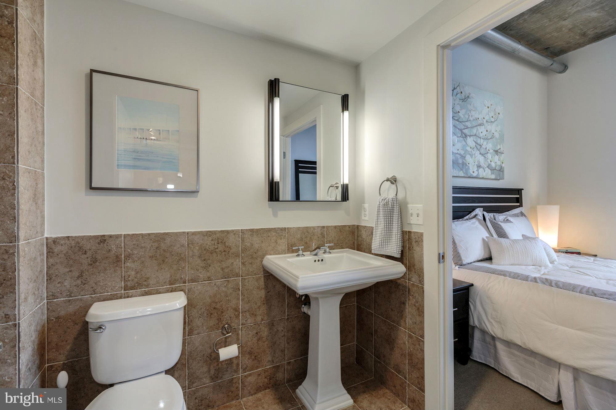 2301 Champlain Street Northwest, Unit 112 Washington, DC 20009 - Photo 17 of 29 a bathroom with a toilet sink and mirror