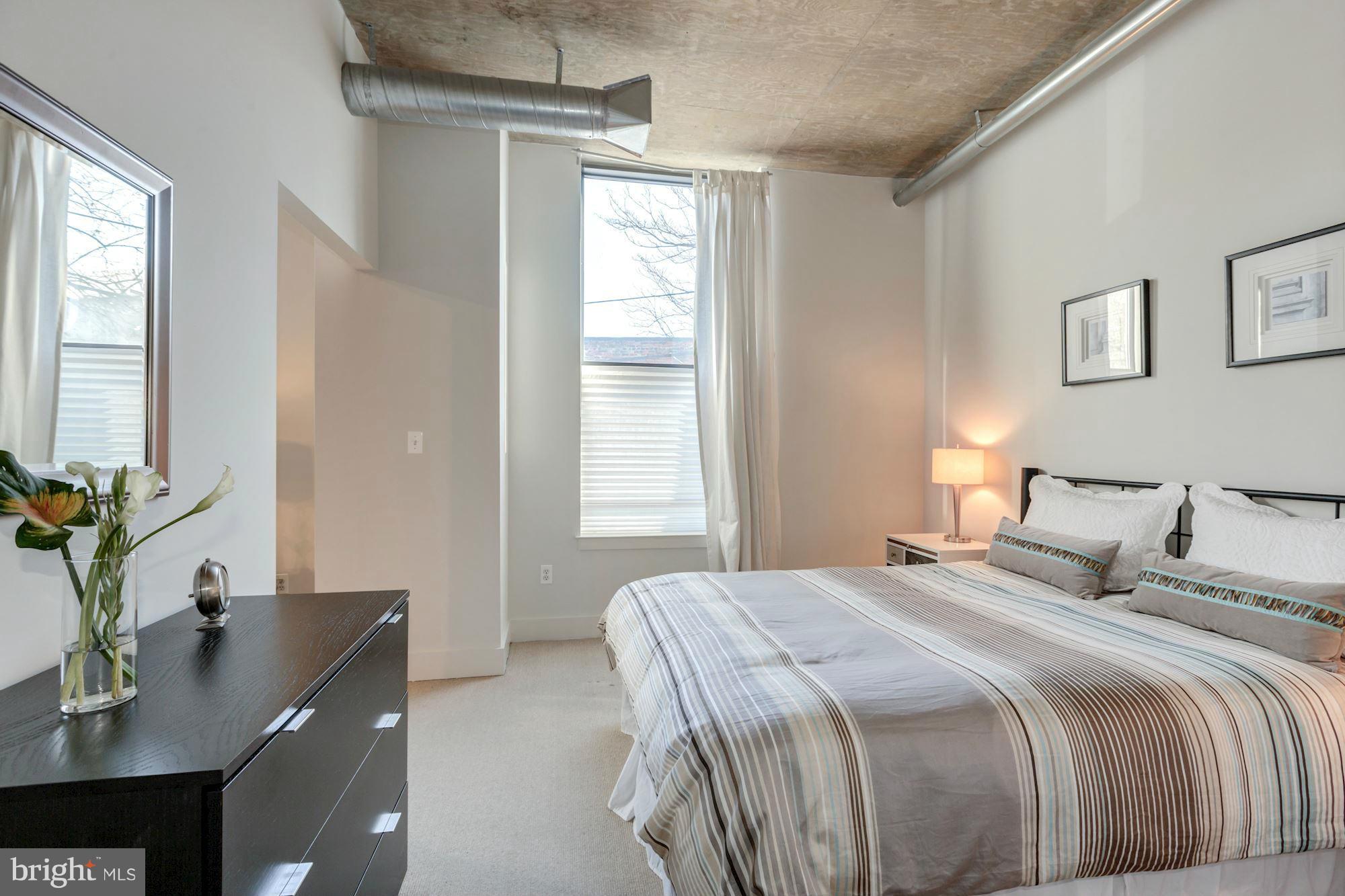 2301 Champlain Street Northwest, Unit 112 Washington, DC 20009 - Photo 20 of 29 a bedroom with a large bed and a desk