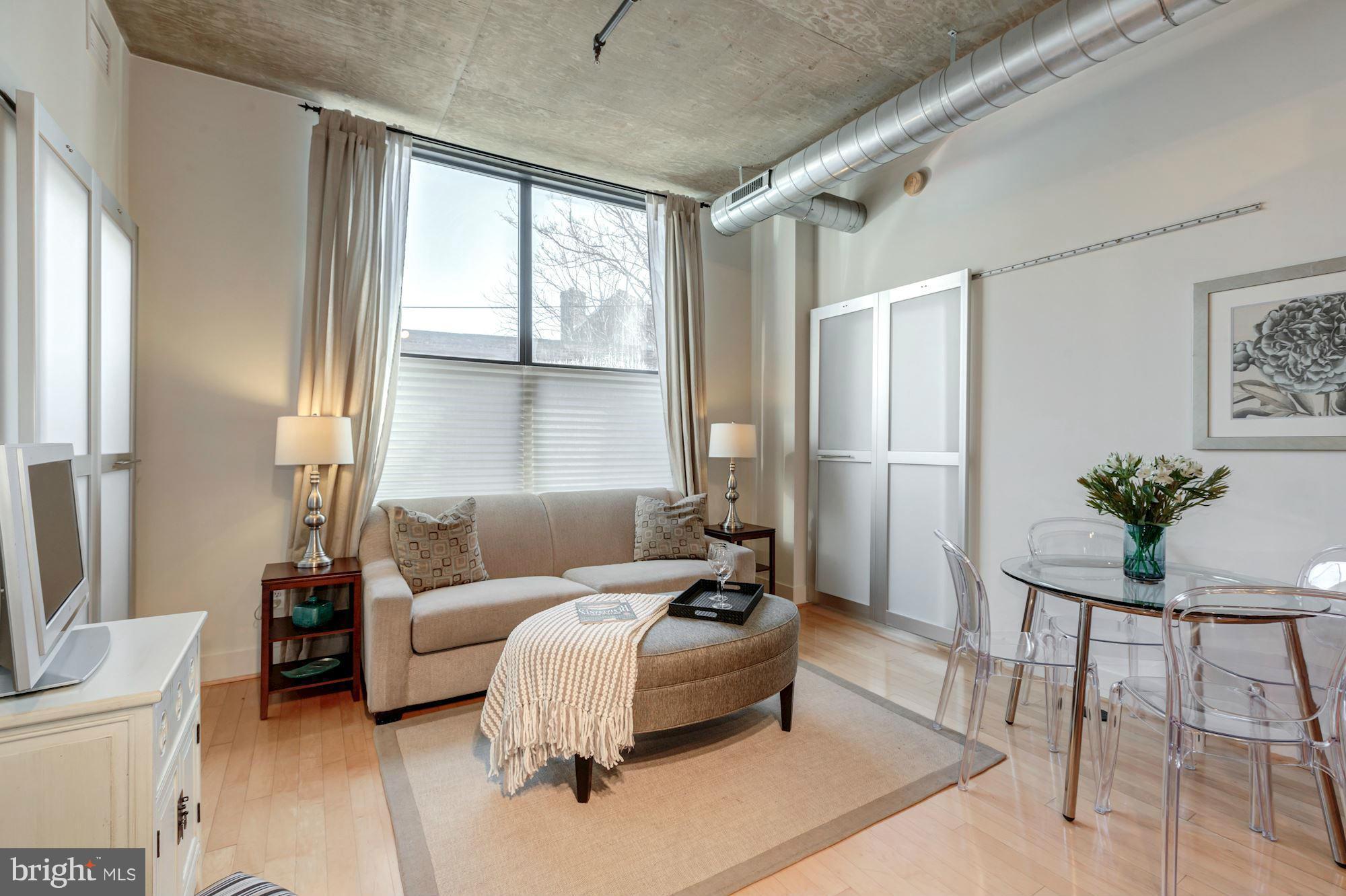 2301 Champlain Street Northwest, Unit 112 Washington, DC 20009 - Photo 3 of 29 a living room with furniture and a large window