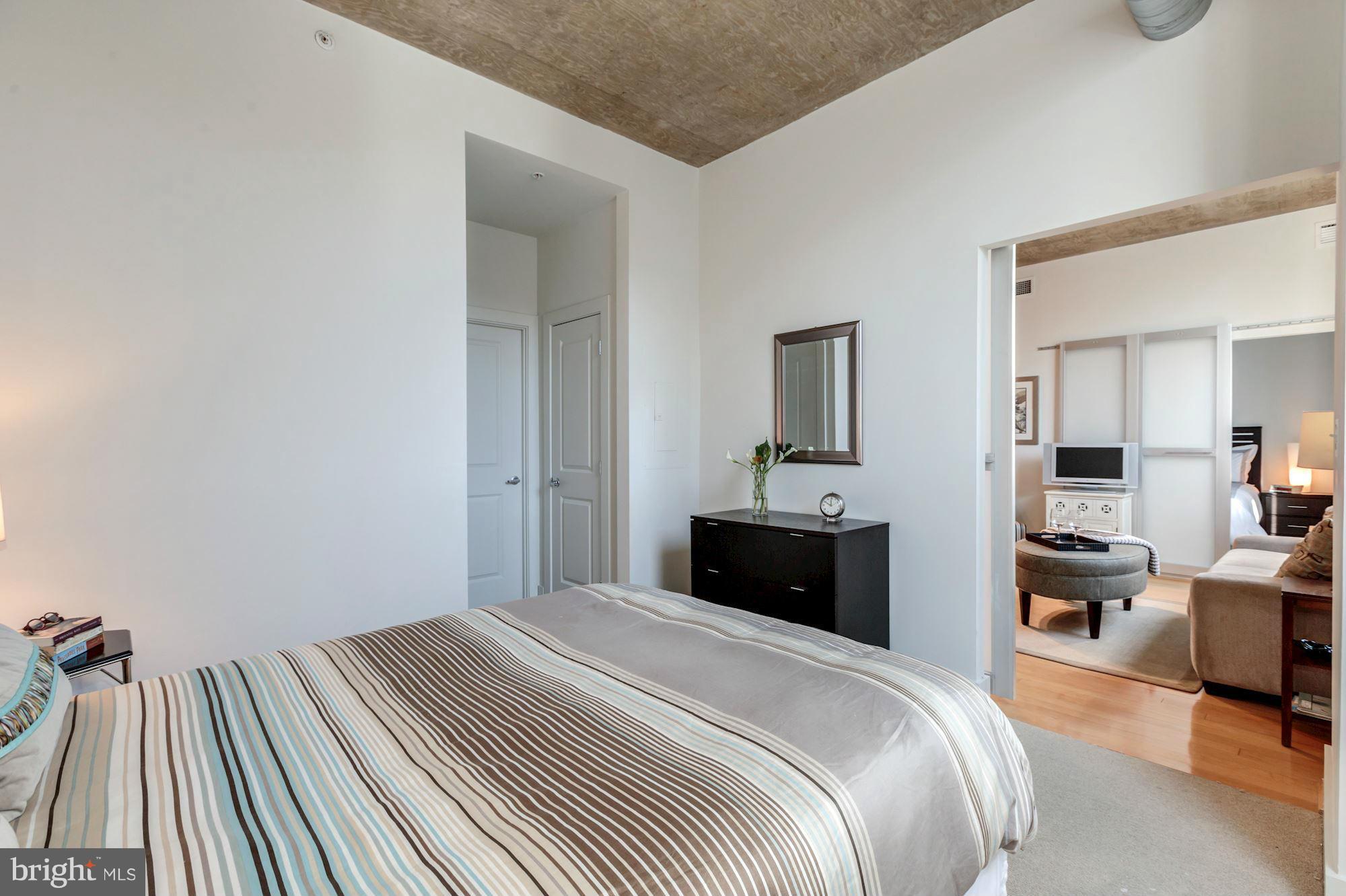 2301 Champlain Street Northwest, Unit 112 Washington, DC 20009 - Photo 21 of 29 a bedroom with a bed and wooden floor