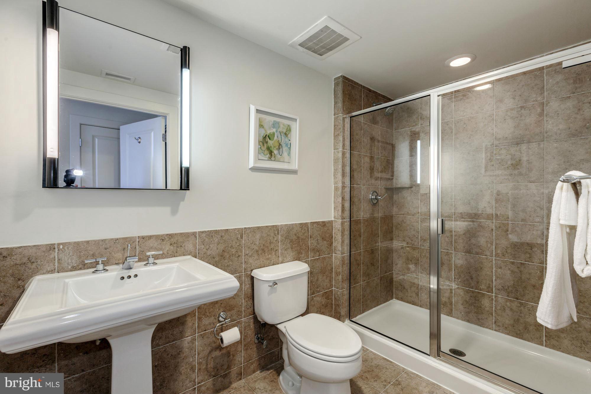 2301 Champlain Street Northwest, Unit 112 Washington, DC 20009 - Photo 25 of 29 a bathroom with a sink toilet and shower