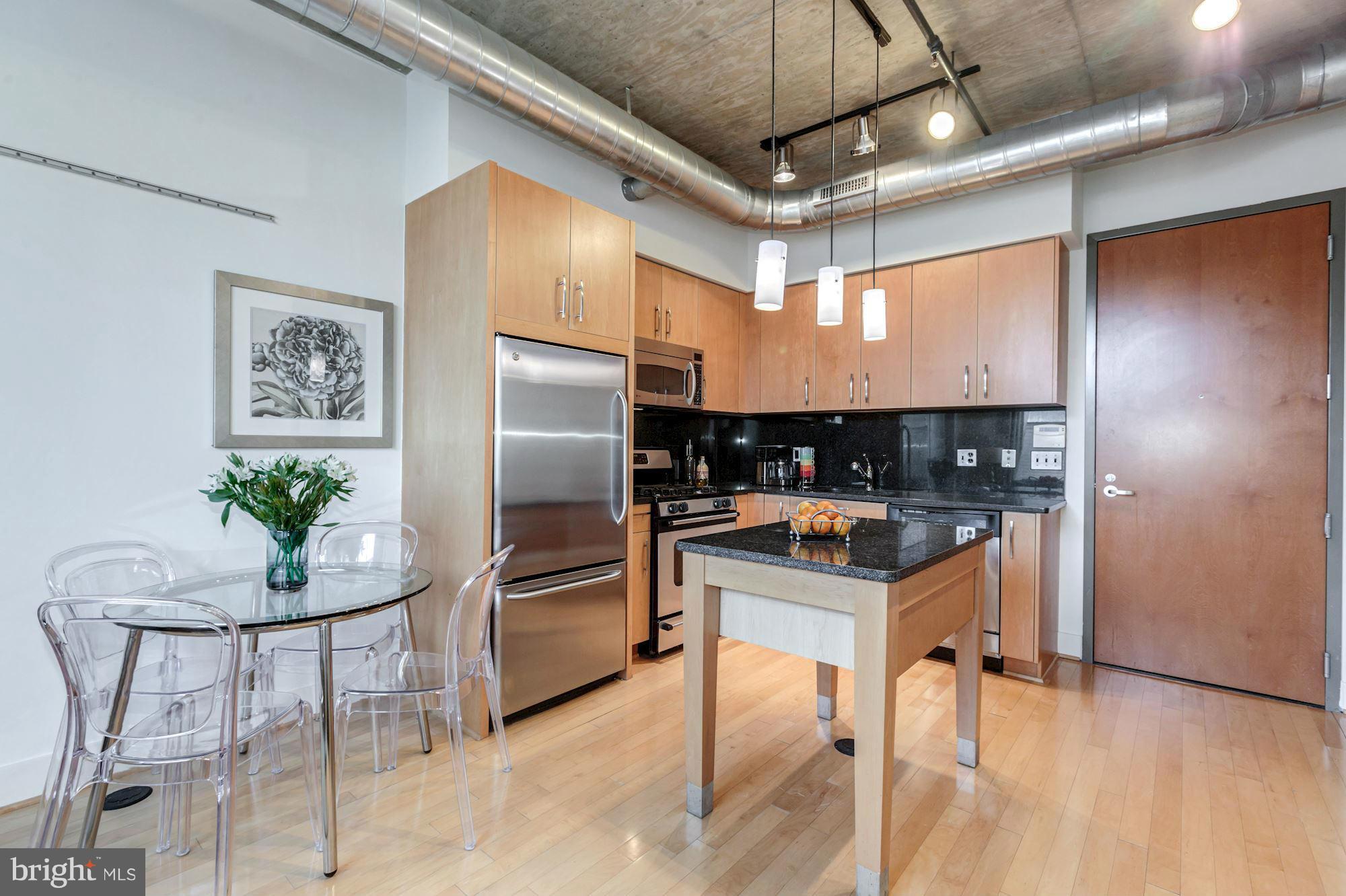 2301 Champlain Street Northwest, Unit 112 Washington, DC 20009 - Photo 9 of 29 a kitchen with stainless steel appliances granite countertop a refrigerator and a stove top oven