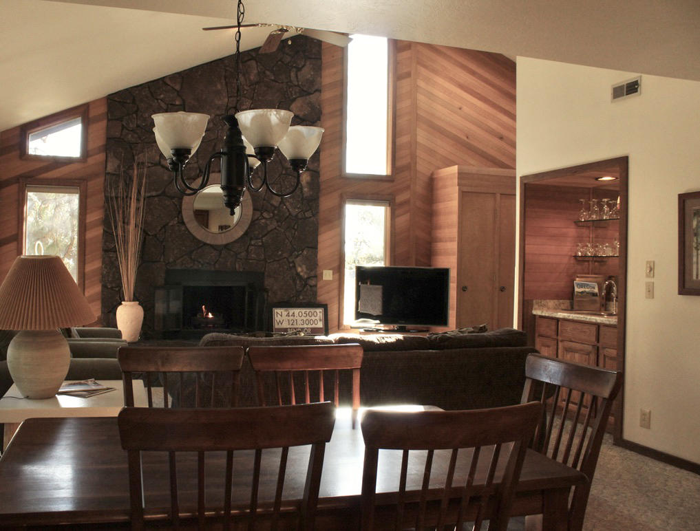 57326-12 Beaver Ridge Loop Sunriver, OR 97707 - Photo 6 of 24 a view of a dining room with furniture and a fireplace