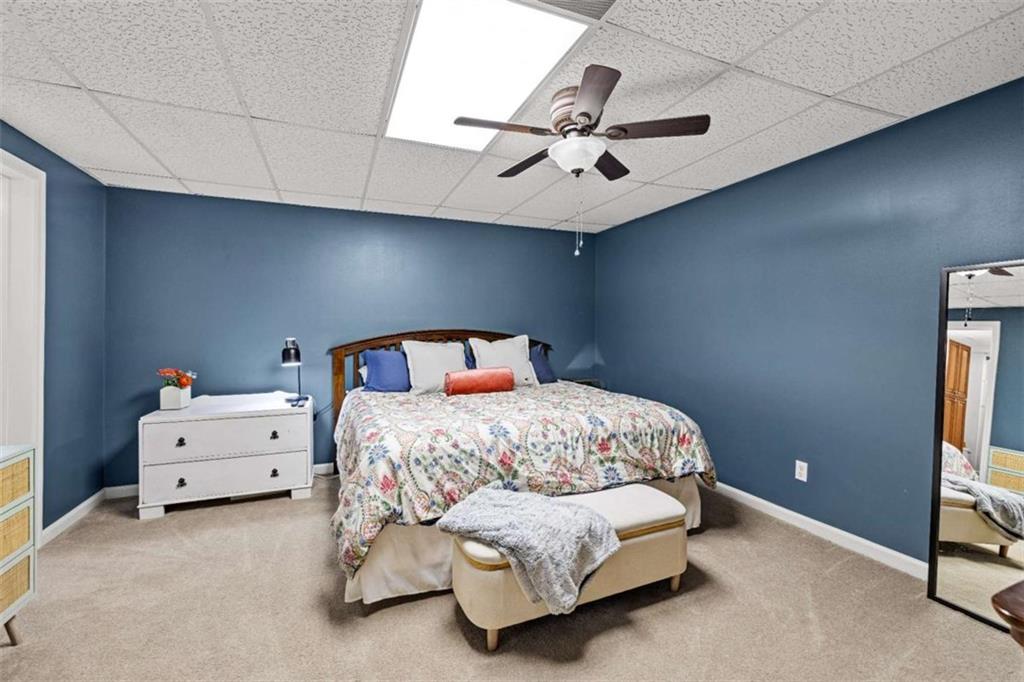 128 Byrom Road Senoia, GA 30276 - Photo 52 of 83 a bedroom with a bed and ceiling fan