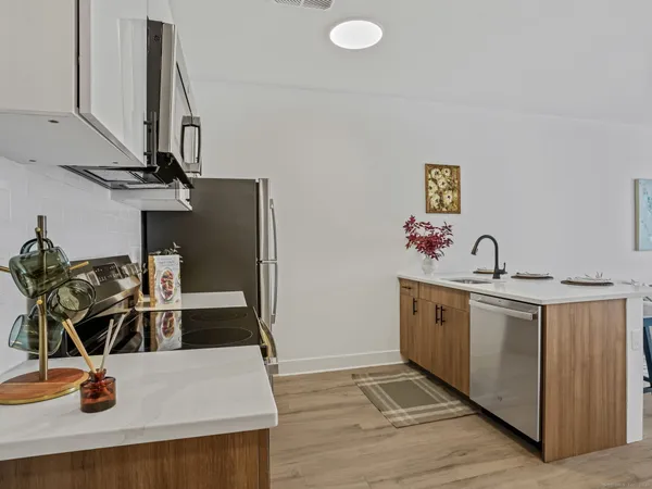 a kitchen with stainless steel appliances granite countertop a sink and a stove