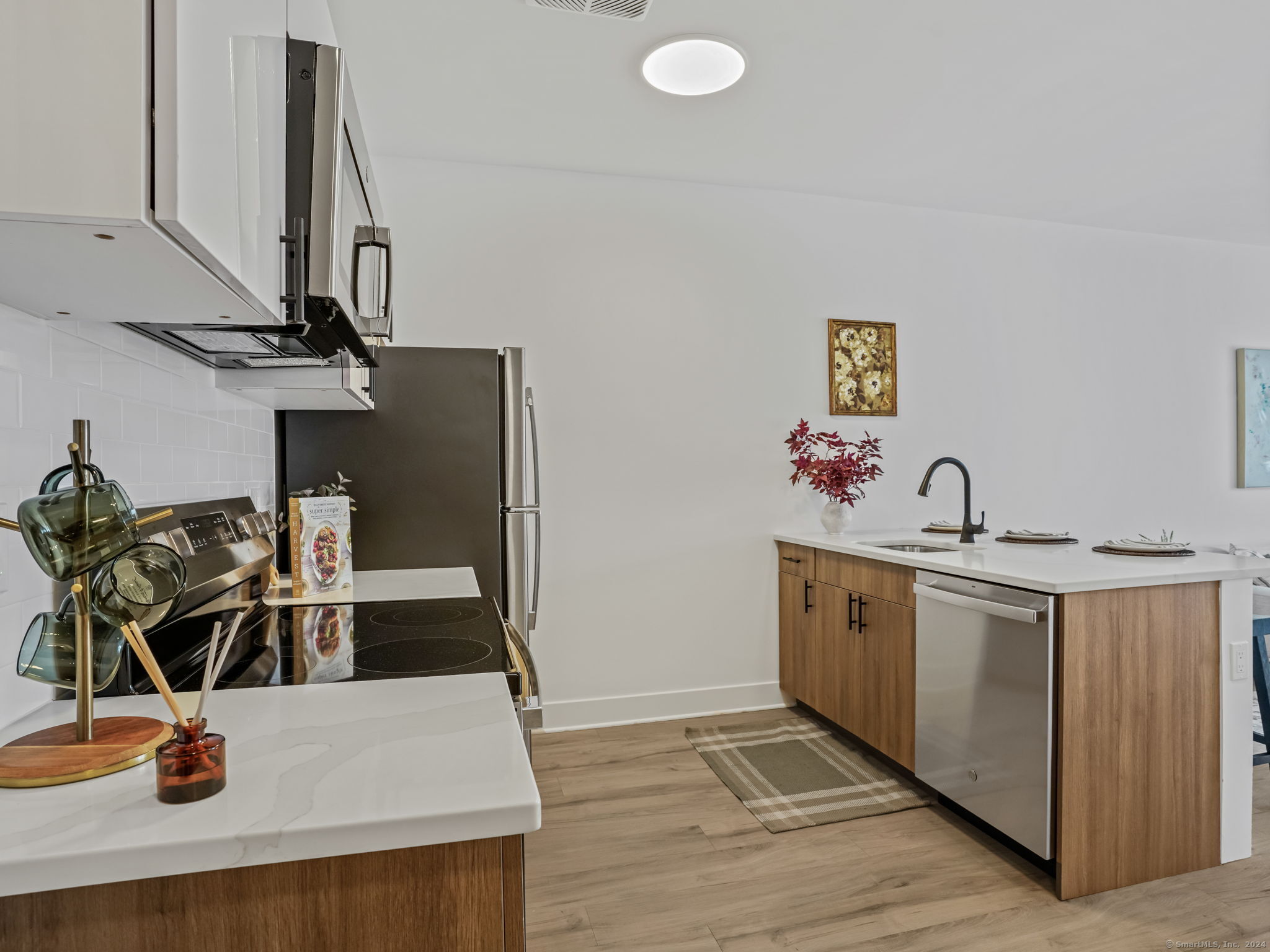 821 East Main Street, Unit 209 Stamford, CT 06902 - Photo 13 of 29 a kitchen with stainless steel appliances granite countertop a sink and a stove