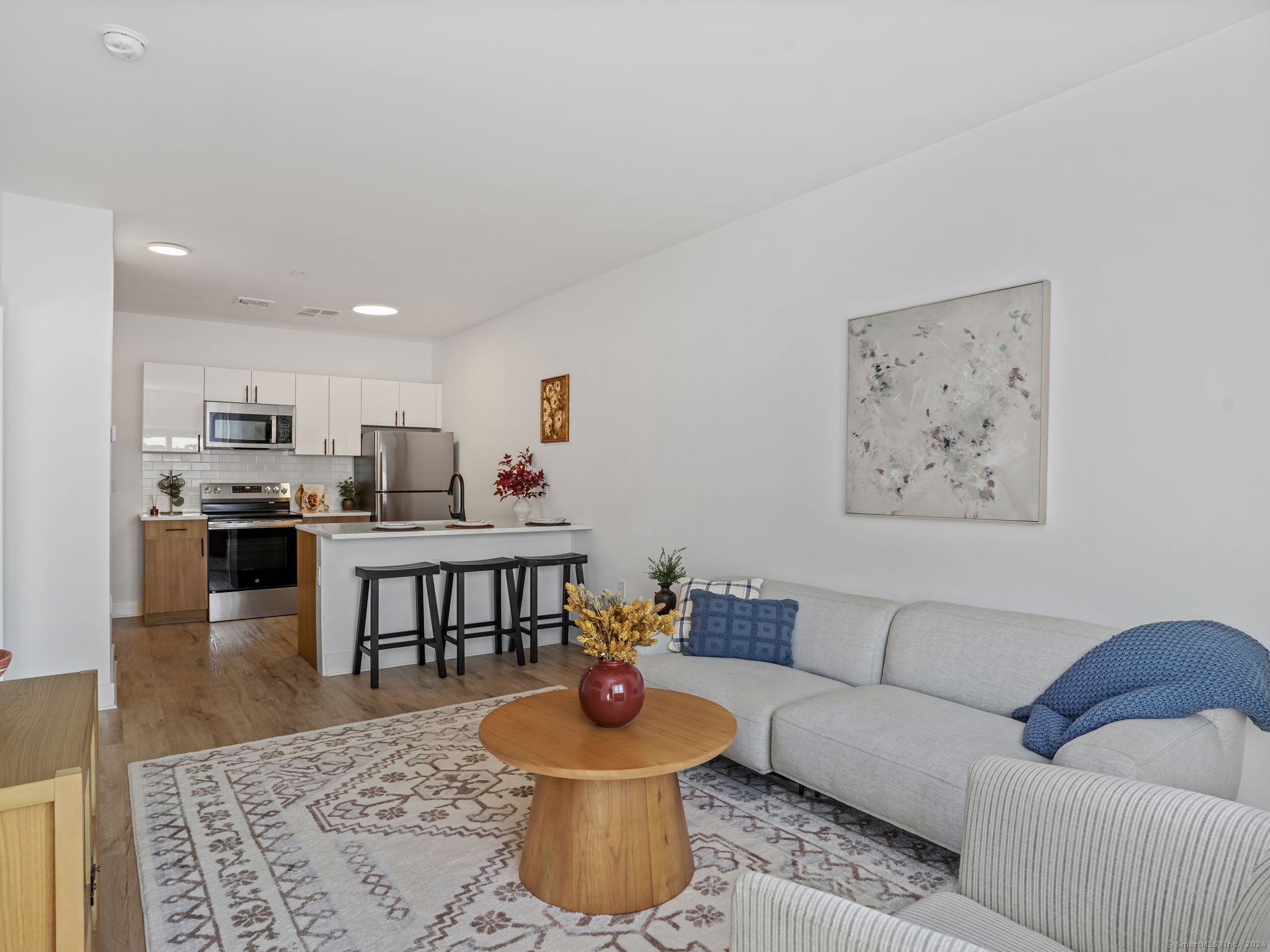 821 East Main Street, Unit 209 Stamford, CT 06902 - Photo 14 of 29 a living room with furniture and a view of kitchen