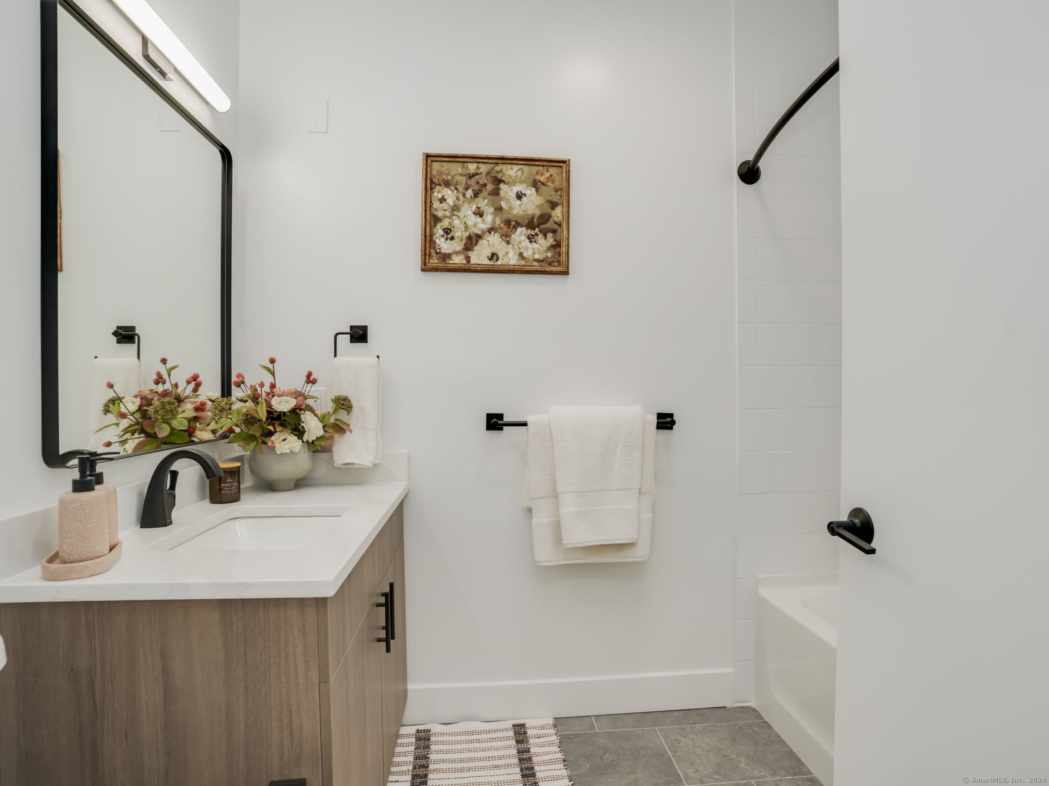 821 East Main Street, Unit 209 Stamford, CT 06902 - Photo 16 of 29 a bathroom with a sink a mirror and shower