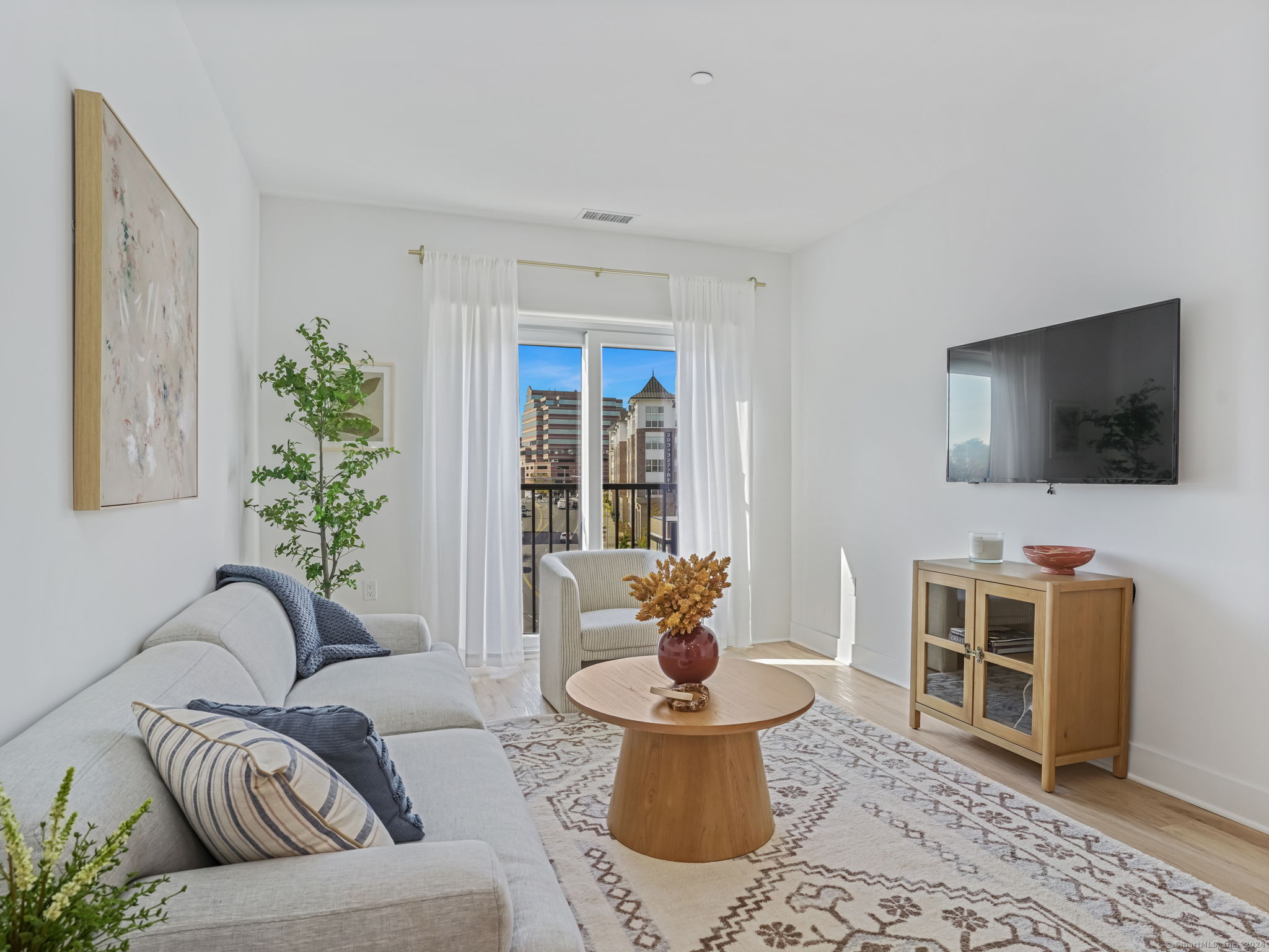 821 East Main Street, Unit 209 Stamford, CT 06902 - Photo 19 of 29 a living room with furniture and a flat screen tv