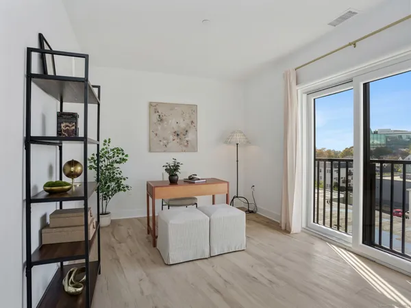 a living room with furniture and a floor to ceiling window