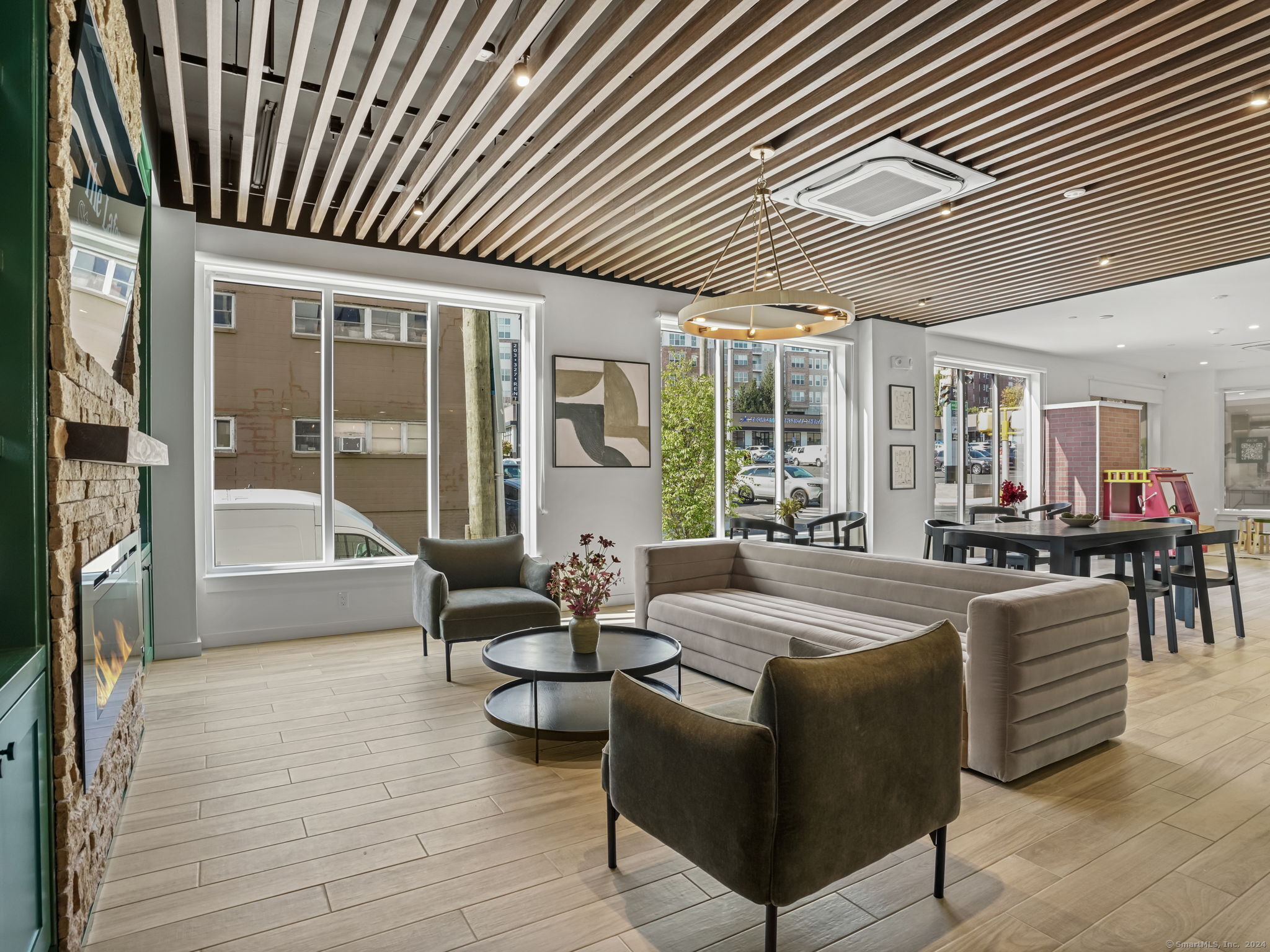 821 East Main Street, Unit 209 Stamford, CT 06902 - Photo 6 of 29 a living room with furniture a large window and wooden floor