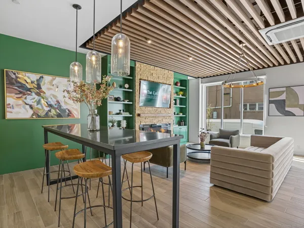 a dining room with furniture and wooden floor