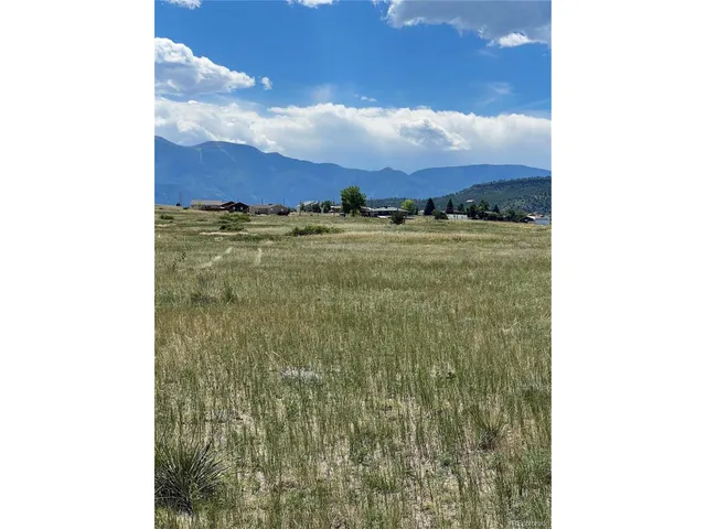 a view of a dry yard with an buildings