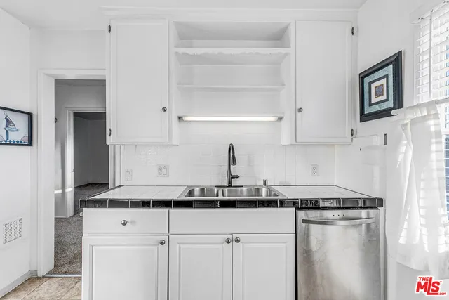 a kitchen with stainless steel appliances a refrigerator and cabinets