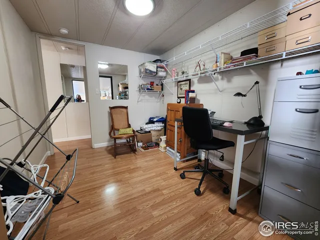 a view of a workspace with furniture and wooden floor