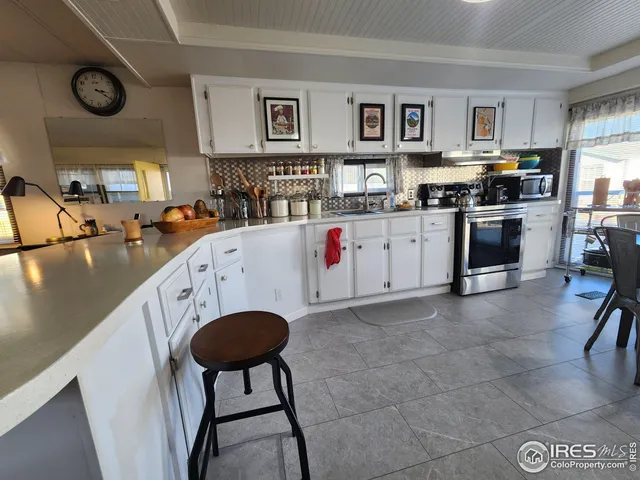 a kitchen with stainless steel appliances a stove a sink and a refrigerator
