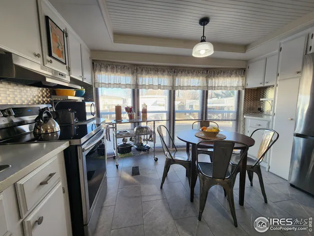 a view of a dining room with furniture window and outside view