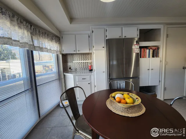 a kitchen with stainless steel appliances granite countertop a stove a refrigerator and a dining table