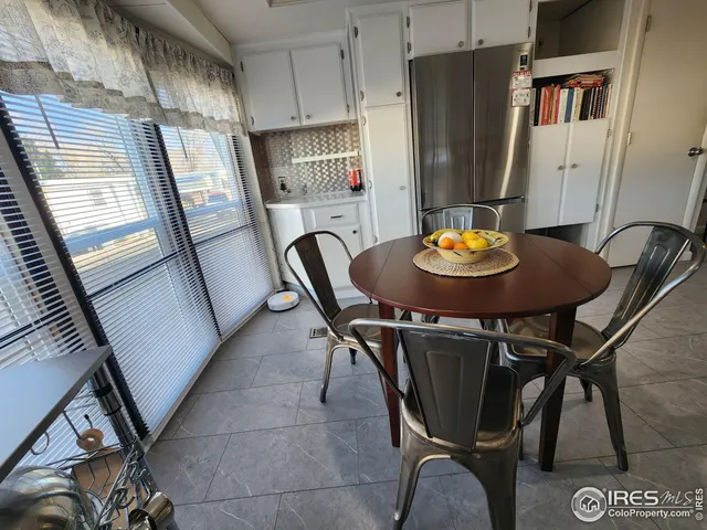 a view of a dining room with furniture and a potted plant