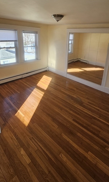 22 Endicott Street, Unit 3 Norwood, MA 02062 - Photo 11 of 22 a view of empty room with window and wooden floor