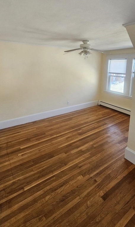 22 Endicott Street, Unit 3 Norwood, MA 02062 - Photo 13 of 22 an empty room with wooden floor fan and windows