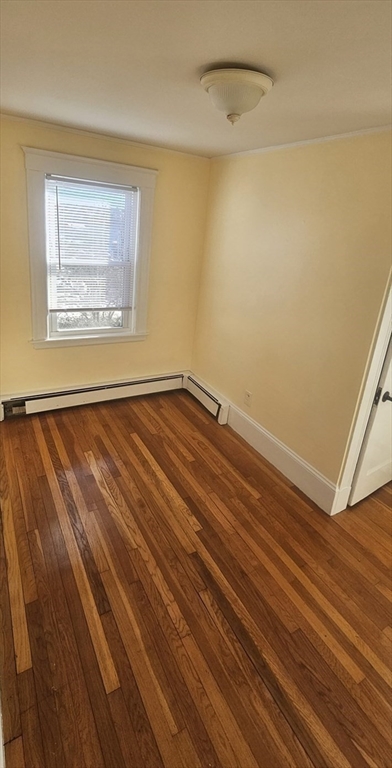 22 Endicott Street, Unit 3 Norwood, MA 02062 - Photo 15 of 22 a view of an empty room with wooden floor and a window