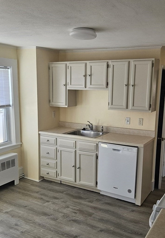 22 Endicott Street, Unit 3 Norwood, MA 02062 - Photo 3 of 22 a kitchen with stainless steel appliances granite countertop a stove a sink and a refrigerator with wooden floors