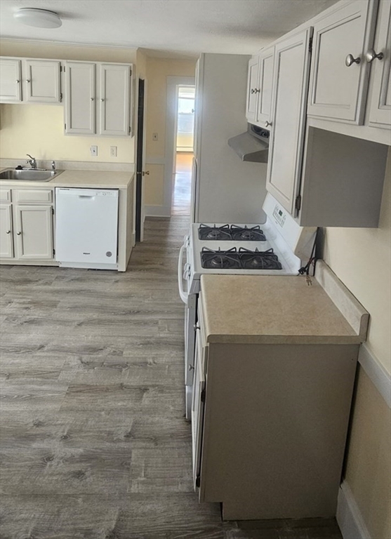 22 Endicott Street, Unit 3 Norwood, MA 02062 - Photo 5 of 22 a kitchen with a stove and a refrigerator