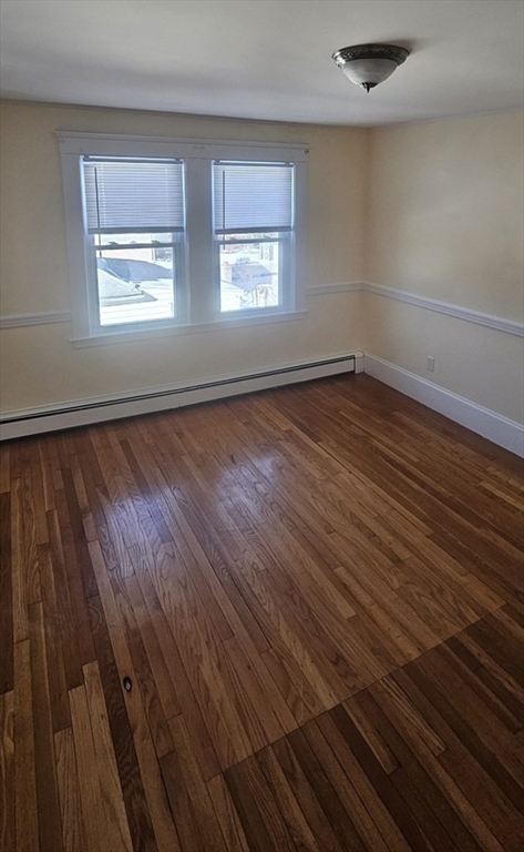 22 Endicott Street, Unit 3 Norwood, MA 02062 - Photo 8 of 22 an empty room with wooden floor and windows