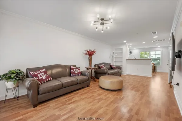 a living room with furniture and a chandelier