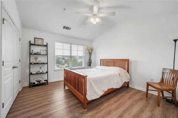 a bedroom with a bed and a chair