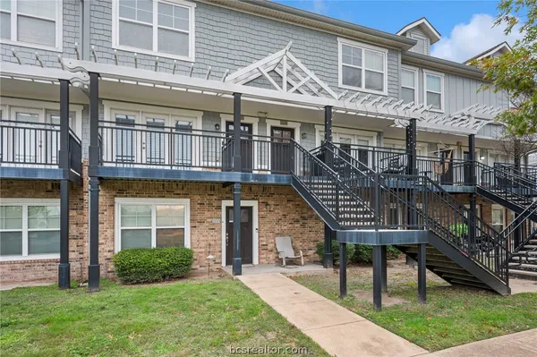 a front view of a house with a garden and plants