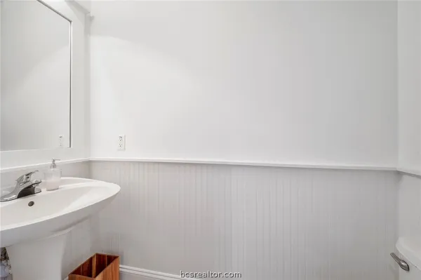 a bathroom with a sink and mirror