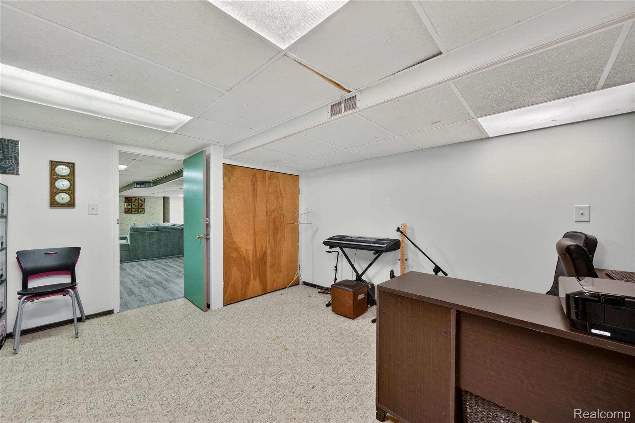 18178 22 Mile Road Macomb, MI 48044 - Photo 36 of 43 Room featuring white walls and a drop-tile ceiling with integrated fluorescent lighting