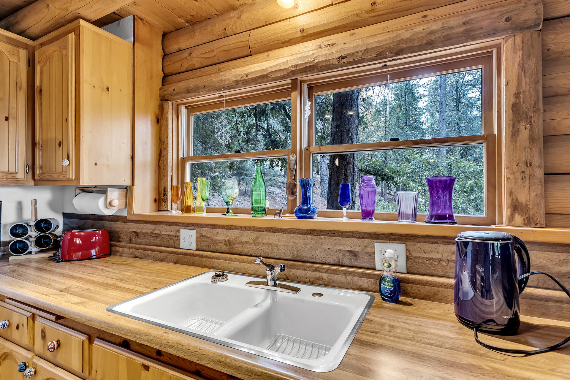 25121 Pine Cove Road Idyllwild, CA 92549 - Photo 12 of 65 a kitchen with a stove a sink and a wooden cabinets