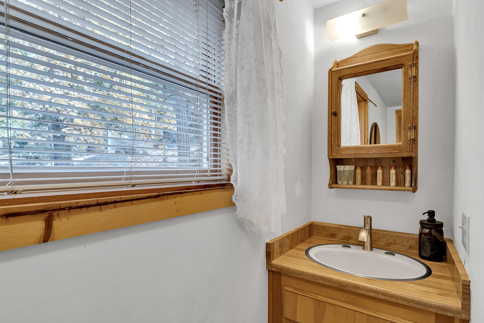 25121 Pine Cove Road Idyllwild, CA 92549 - Photo 26 of 65 a bathroom with a sink and a mirror