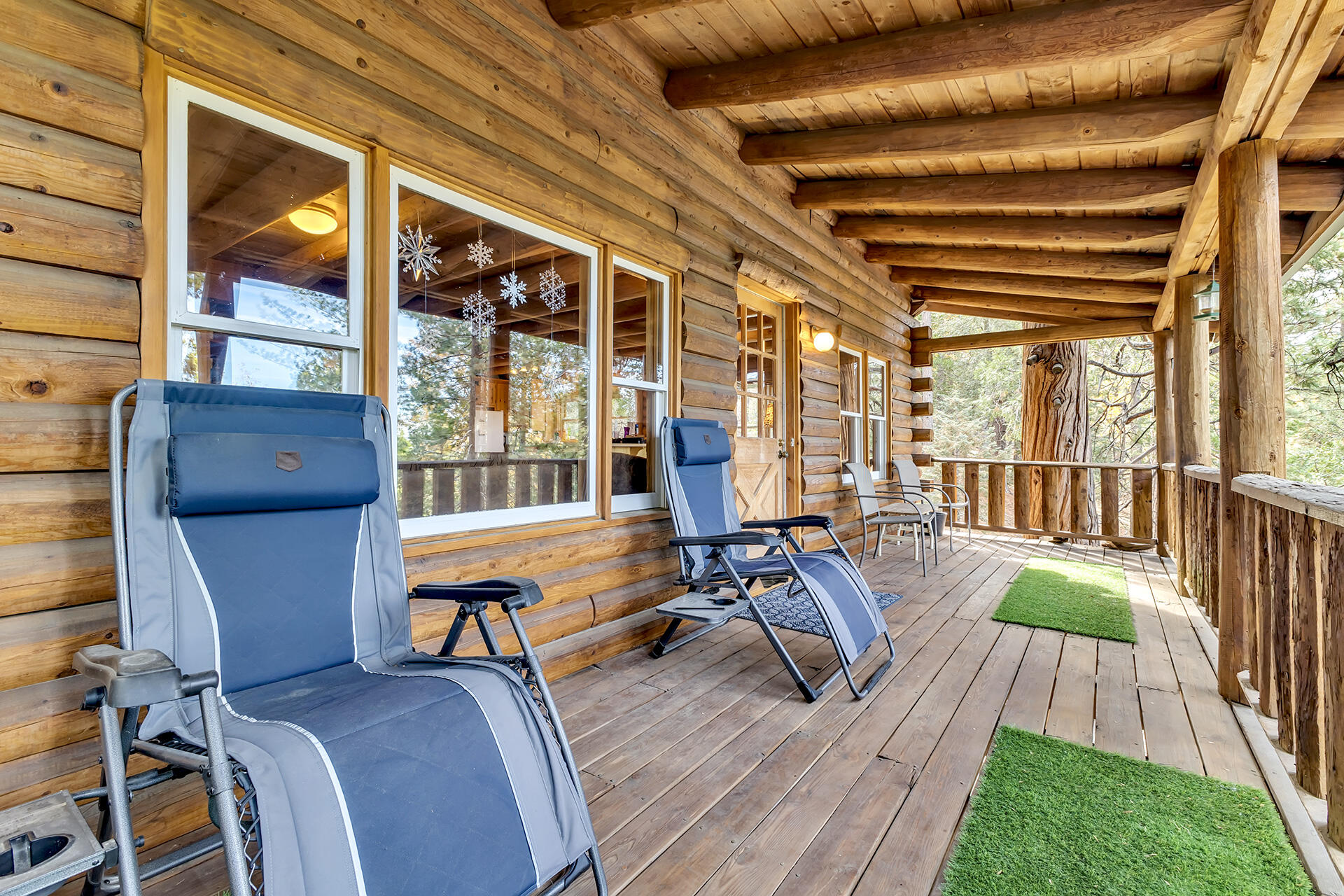 25121 Pine Cove Road Idyllwild, CA 92549 - Photo 32 of 65 a balcony with wooden floor table and chairs