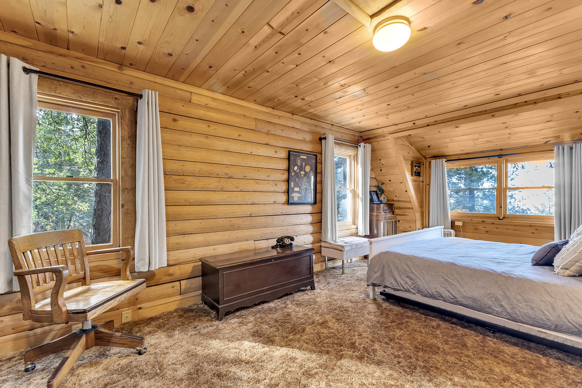 25121 Pine Cove Road Idyllwild, CA 92549 - Photo 35 of 65 a bedroom with a bed and large windows