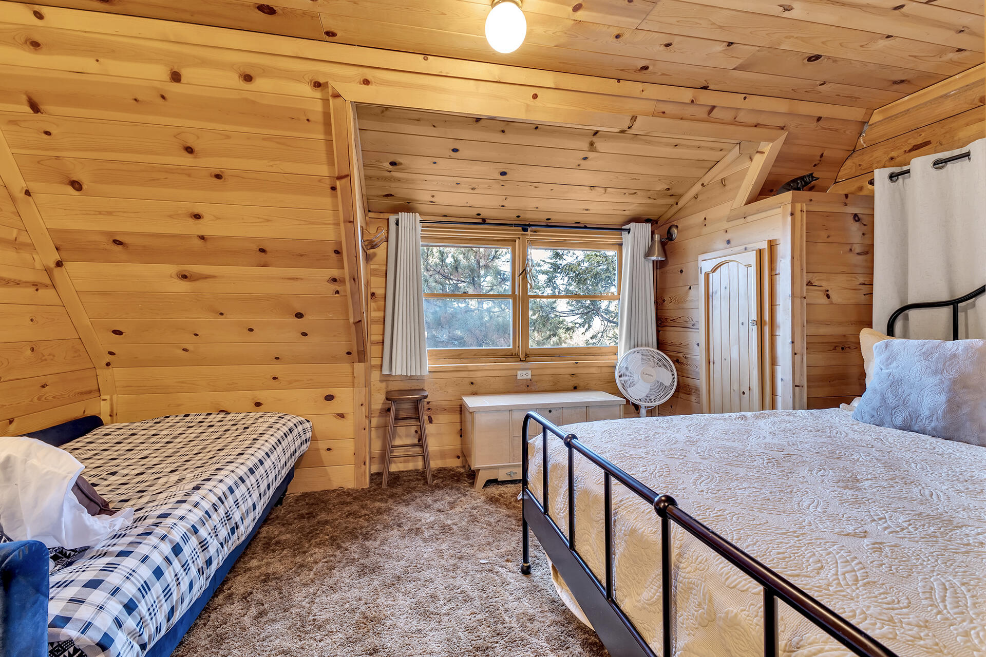 25121 Pine Cove Road Idyllwild, CA 92549 - Photo 40 of 65 a bedroom with a bed and wooden floor