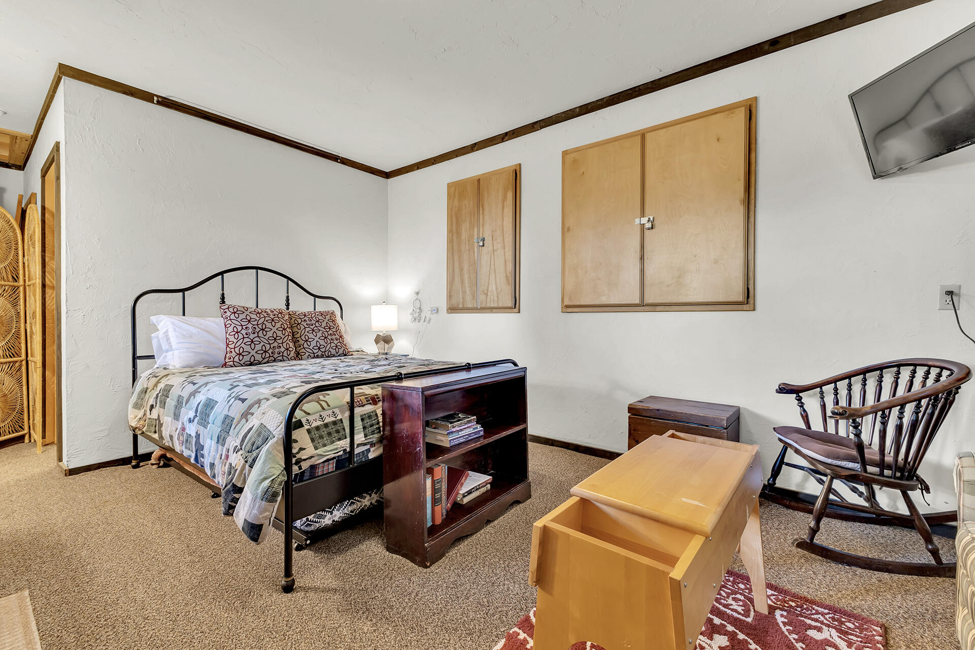 25121 Pine Cove Road Idyllwild, CA 92549 - Photo 52 of 65 a bedroom with a bed and a chair